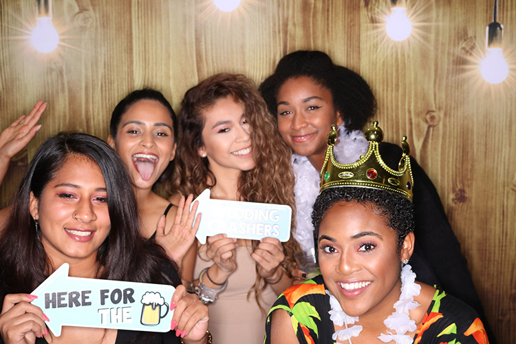 A group of friends using photo booth rental services in Houston, TX