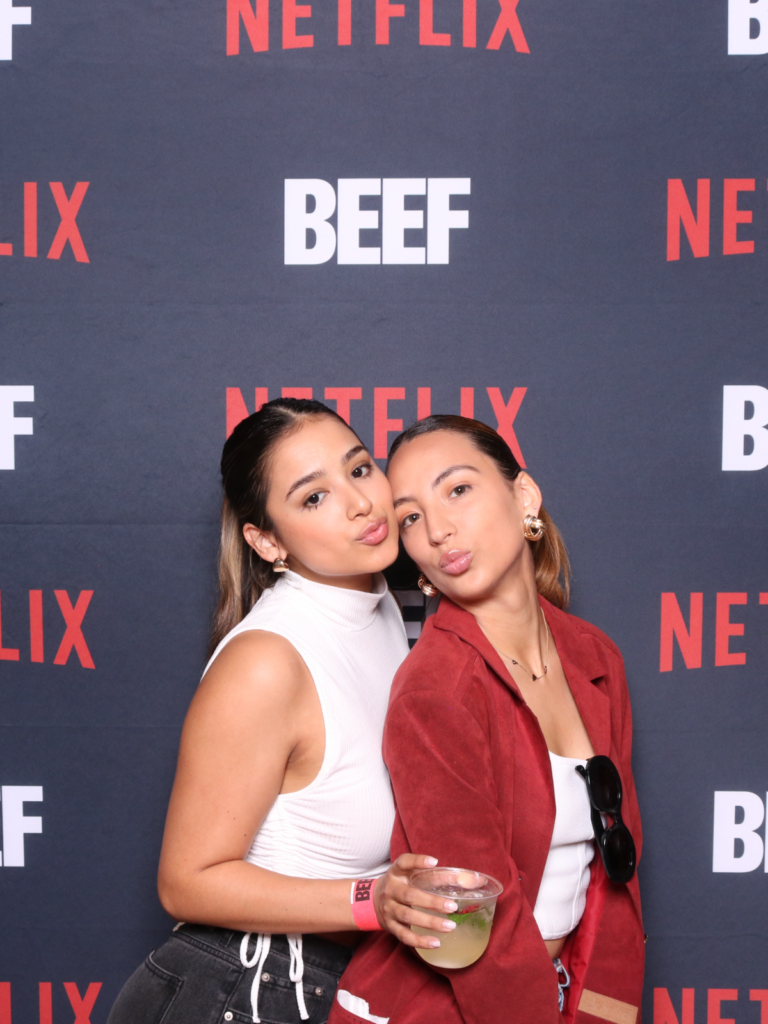 Guests posing at a branded Netflix step-and-repeat activation