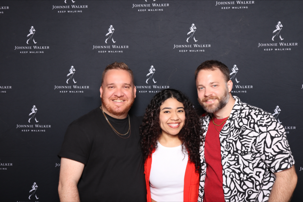 Three guests posing at a Johnnie Walker step-and-repeat