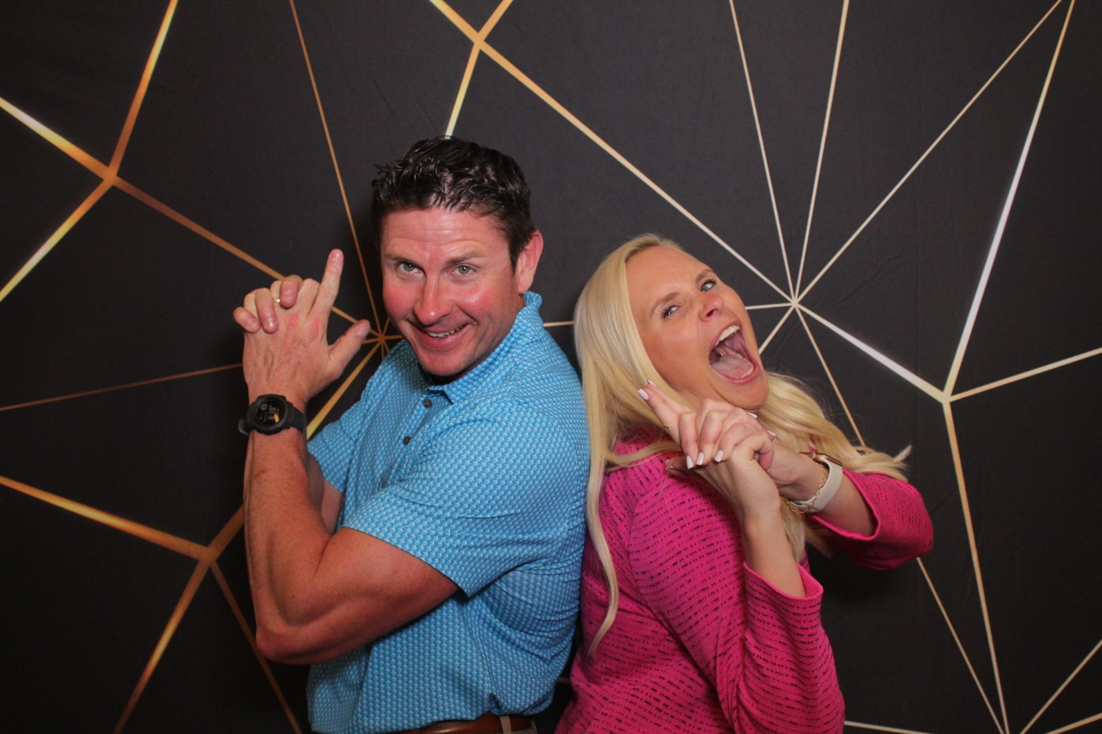 Guests posing at a Houston corporate event photo booth