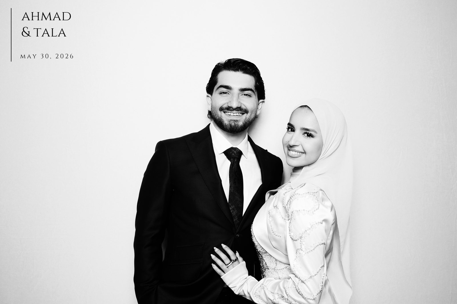 Black-and-white Glam Booth photo of a bride and groom at a Houston wedding